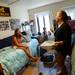 University of Michigan freshman Jenny Veith, of New York, laughs as her new roommate and Tatianna Kroha, of Cali., shows off a broken broom and dust pan damaged in her move as Veith's mom Pam looks on Wednesday morning during move-in at Alice Lloyd Hall. Melanie Maxwell I AnnArbor.com